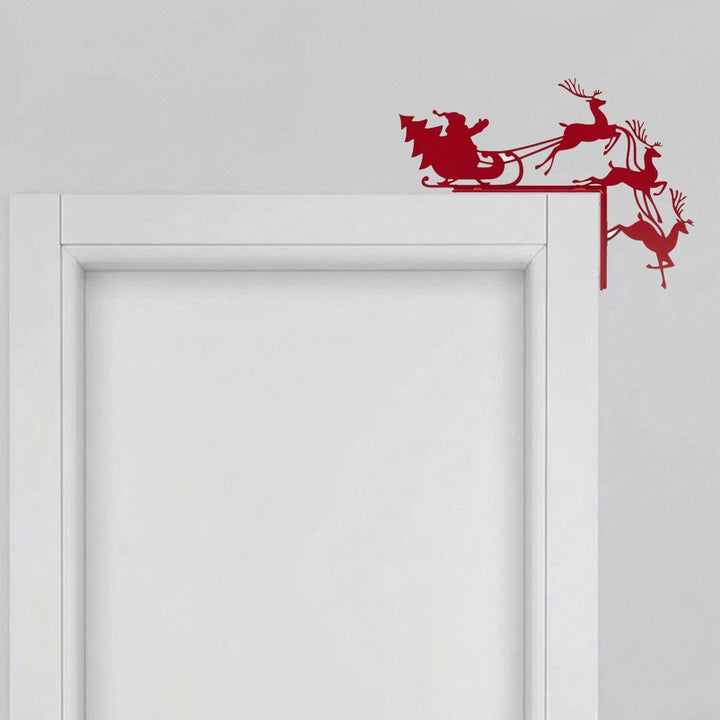 Silueta decorativa de Santa Claus y renos en color rojo mate diseñada para esquinas de puertas y marcos.